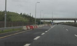 A motorway exit with blocks across it.