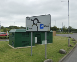 A standard UK roundabout sign with exits signed 'exit', 'fuel' and 'car park'.