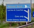 A motorway sign showing two exits: Lorries & Coaches and cars only.