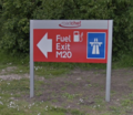 Bright red sign saying 'Fuel, Exit, M20'.