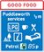 Drawing of a blue road sign saying Puddleworth services ½m, owned by Good Food, with symbols showing LPG, a coffee cup, a fork and spoon, a picnic table, tourist information and a bed, and petrol for 85p.