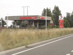 A brick petrol station canopy with Total branding.