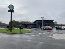 Starbucks Drive Thru building with car park.