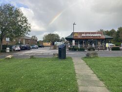 A McDonald's restaurant behind a grass lawn and car park.