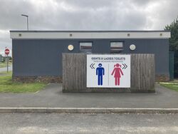 Sign on a building saying gents & ladies toilets; gwer & arloedhes privedhyow.